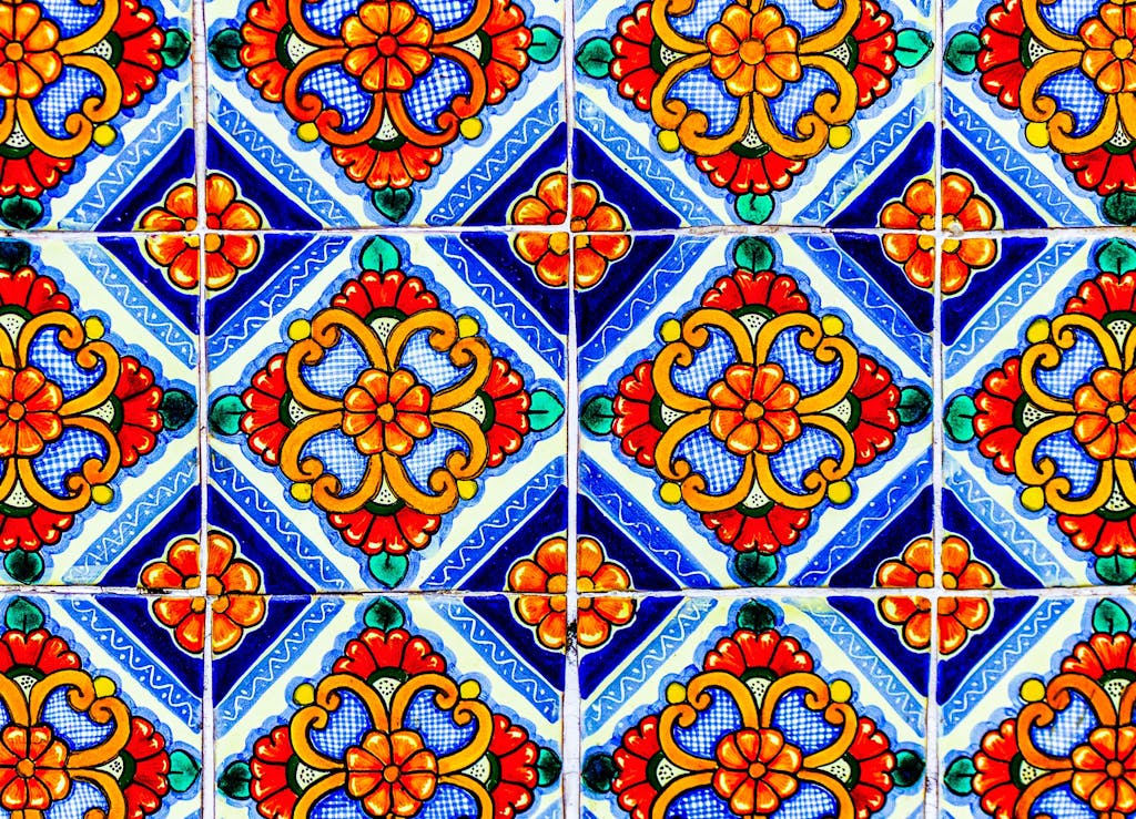 Colorful traditional Mexican Talavera ceramic tile with painted tin glazed floral pattern as abstract background